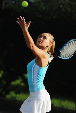 Young Blonde Woman Playing Tennis Serving